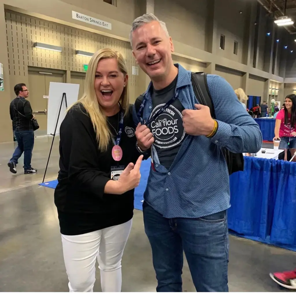 Speaker meeting an attendee on the Hack Your Health expo floor